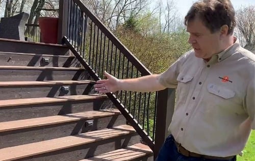 Jamie Dunsing examining exterior deck connections