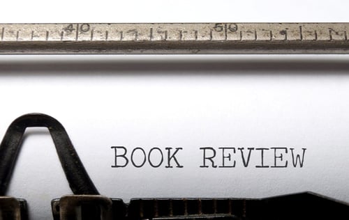 Typewriter and paper with the words Book Review