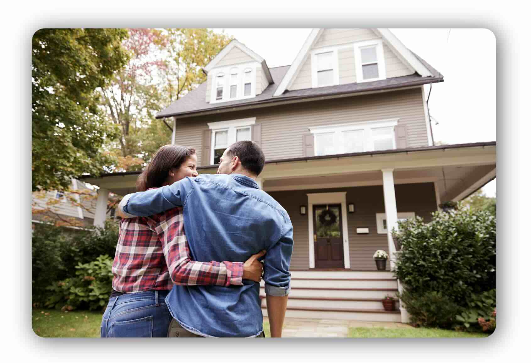 Home buyers standing outside a residential property