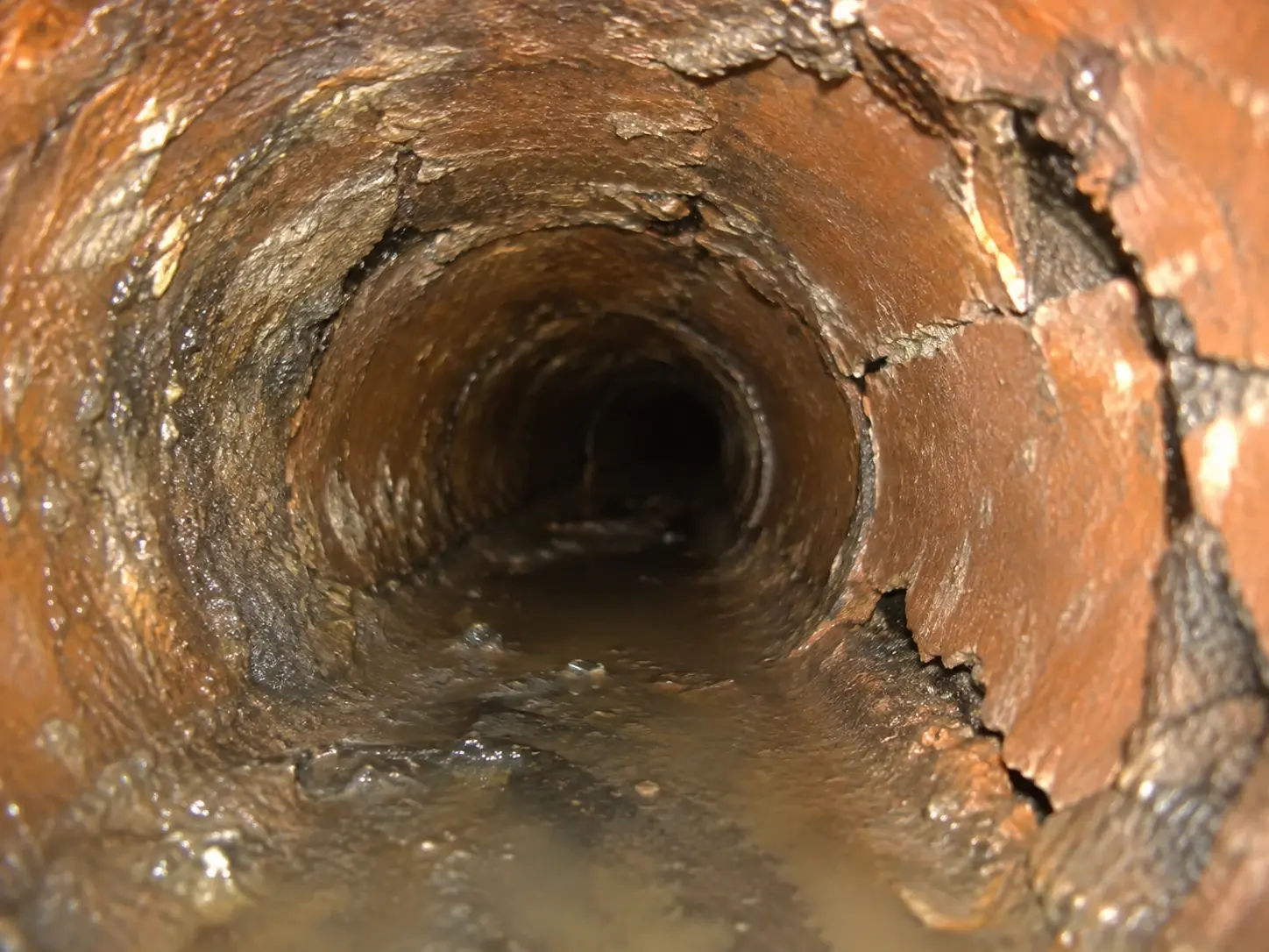 Sewer camera view showing advanced deterioration of an older sewer pipe material