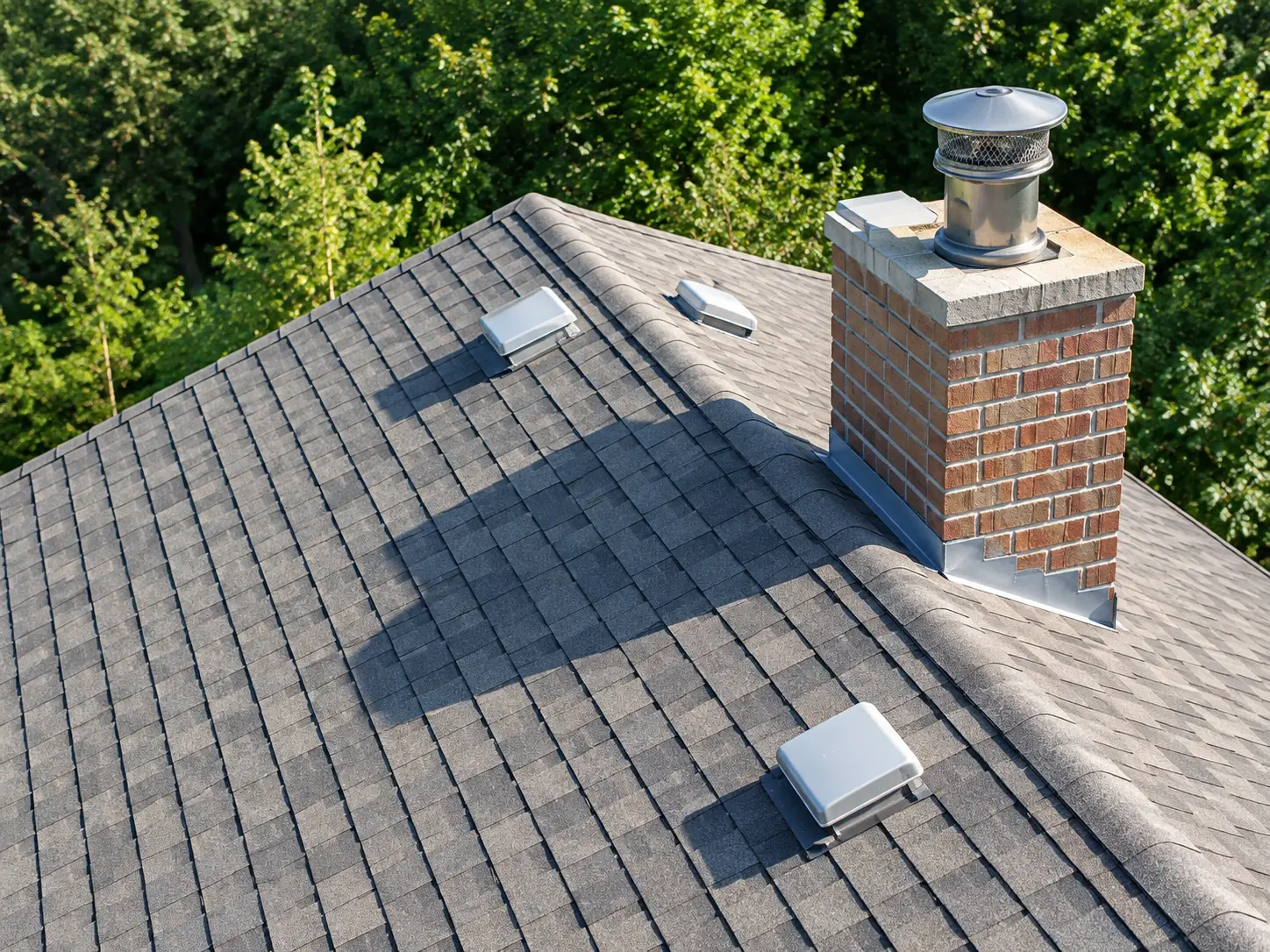 Aerial view of a residential roof and chimney during a drone inspection