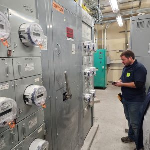 Building inspector examining switchgear during insurance inspection.