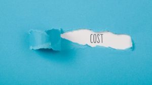 The word cost revealed beneath torn blue paper