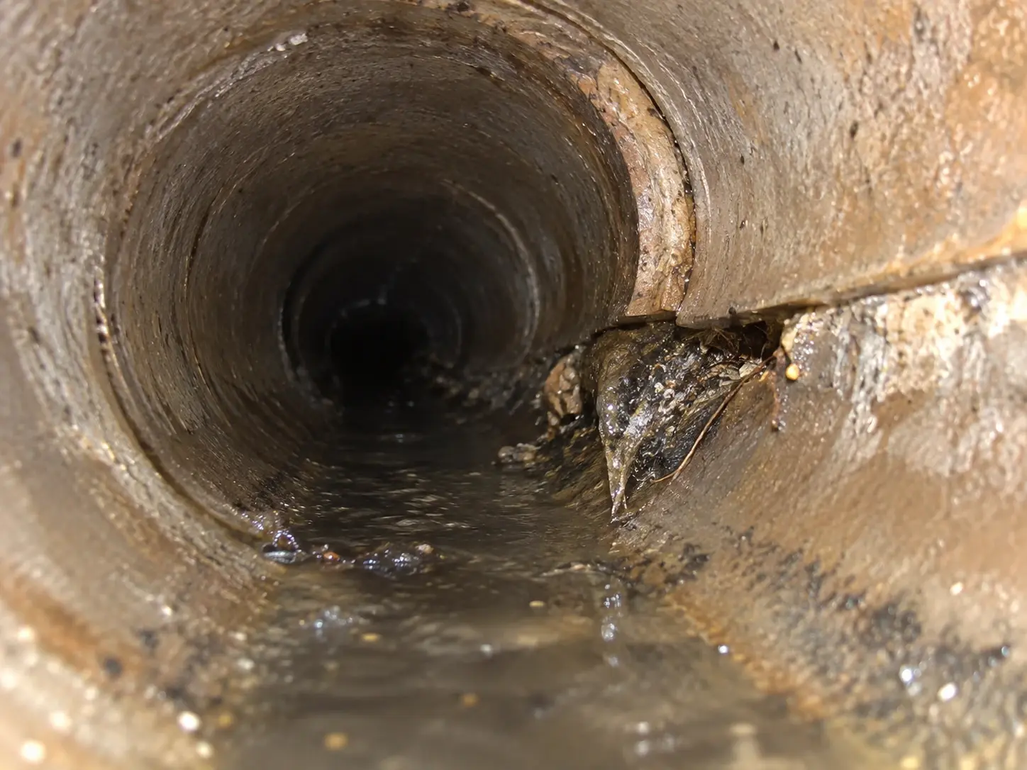 Sewer camera view showing an offset or misaligned joint in a residential sewer line